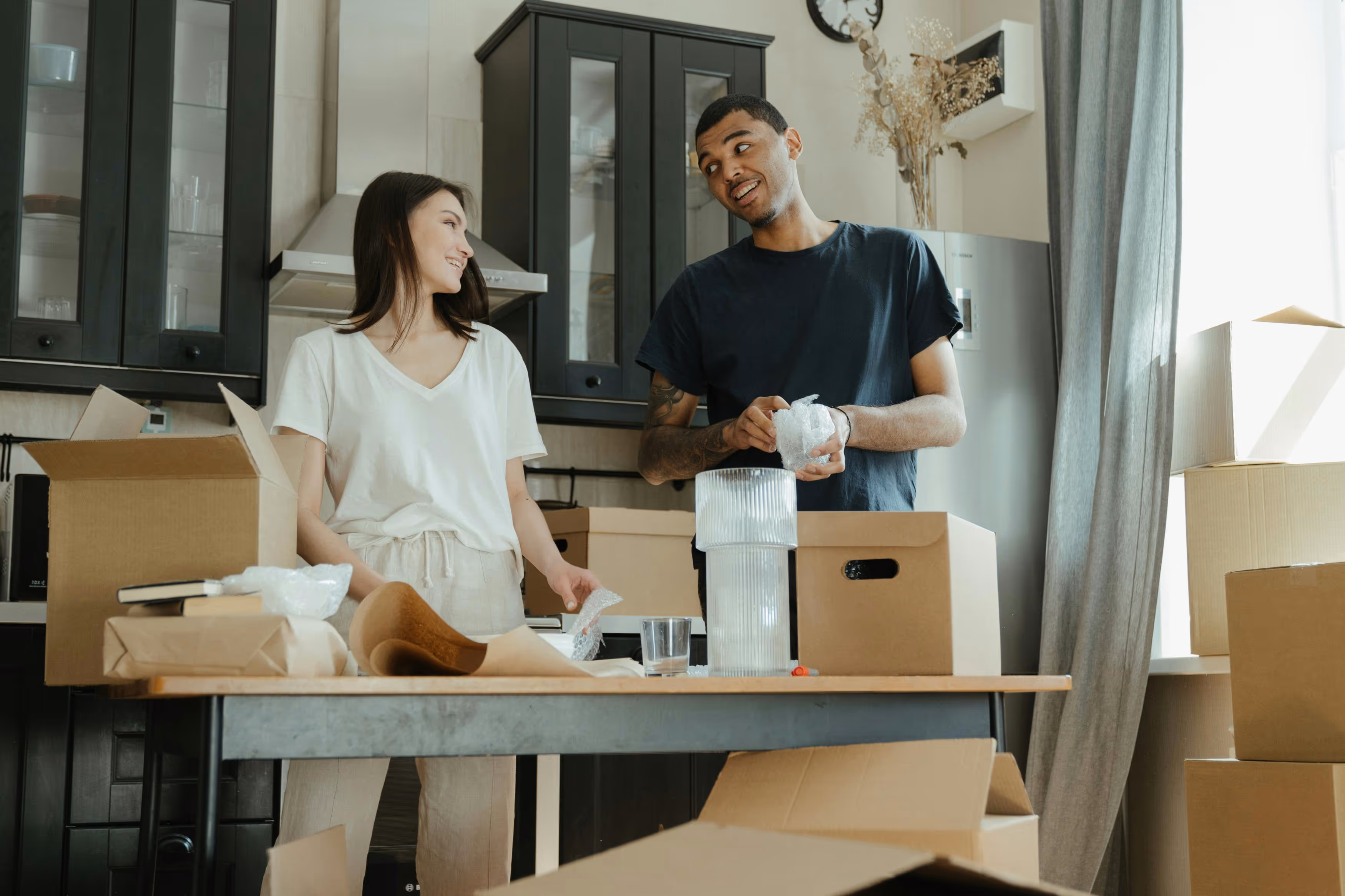 Couple unpacking boxes in their new home